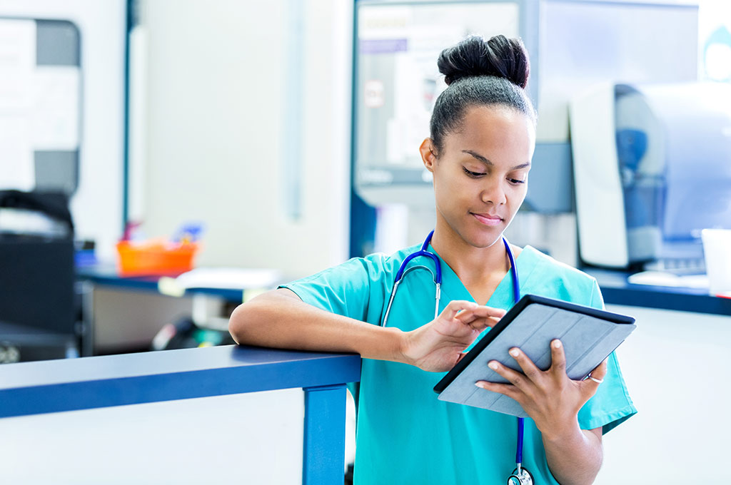 Nurse updates information on a tablet