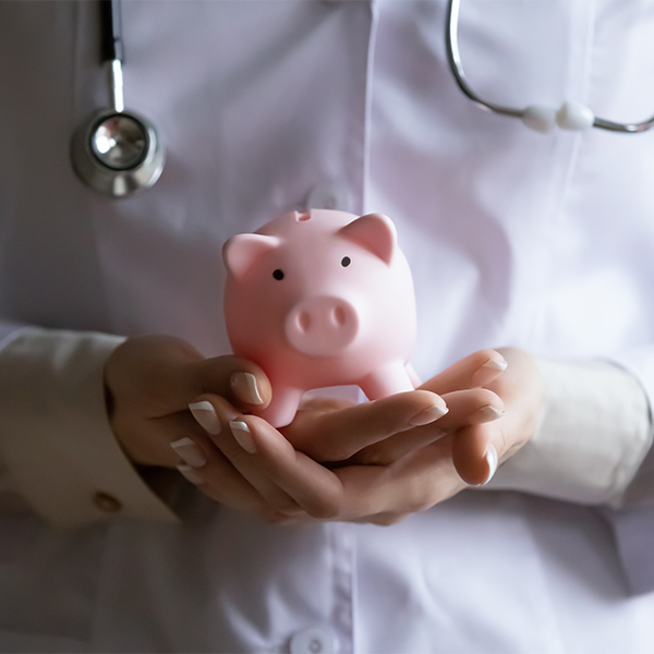 Hands of therapist holding piggy bank closeup view